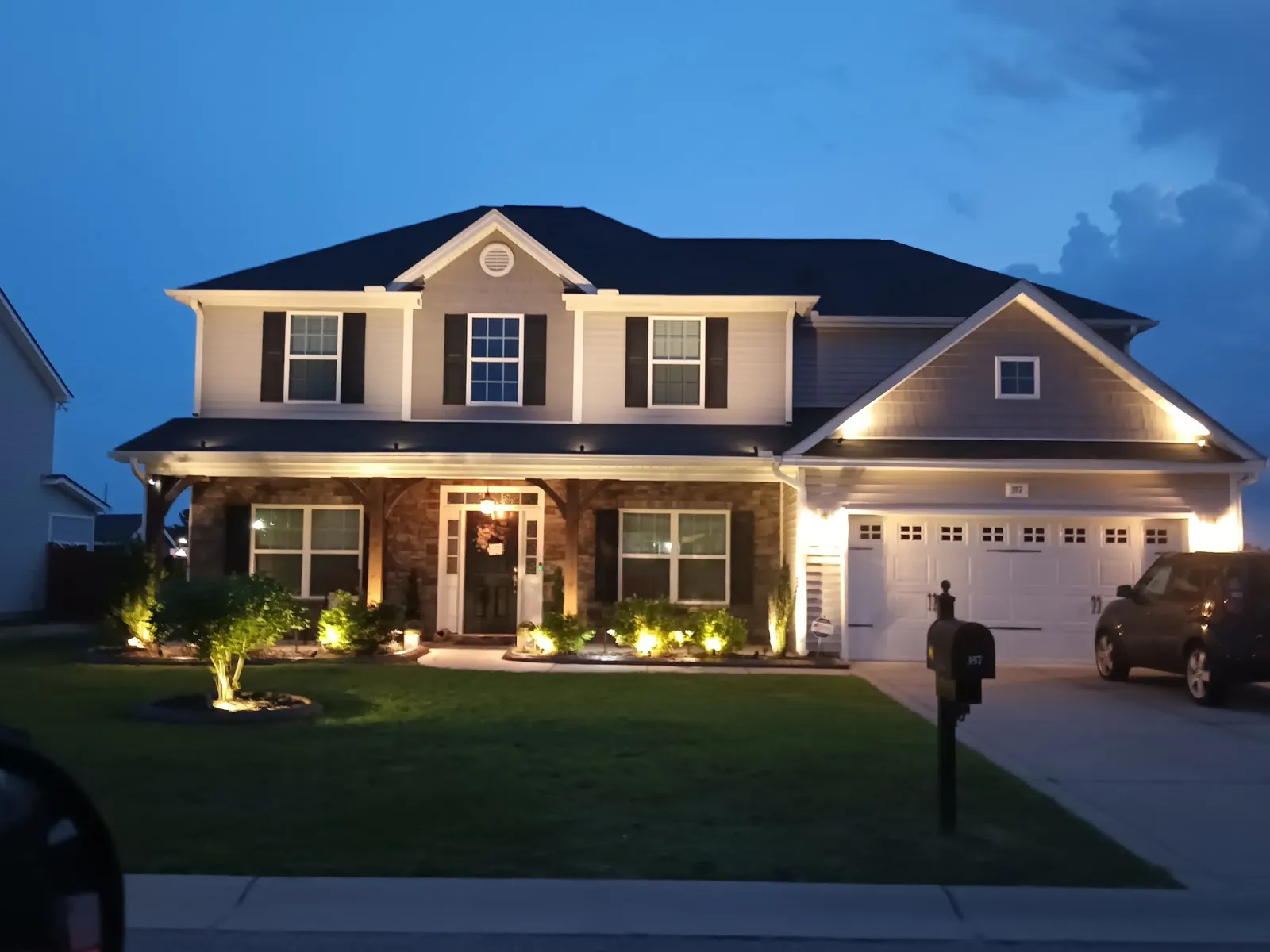 Dusk to dawn landscape lighting on a two-story home Raleigh NC area